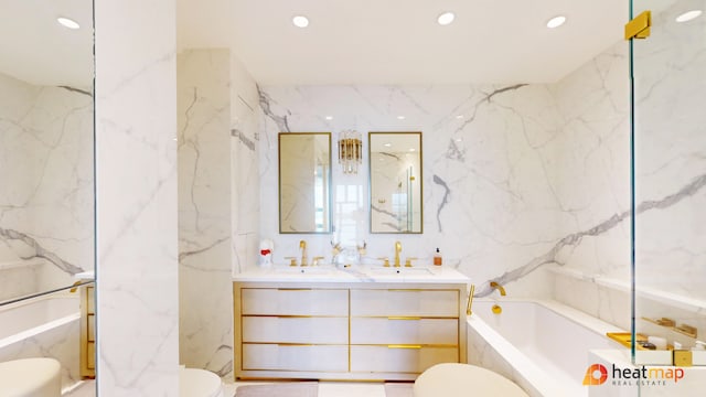 bathroom featuring toilet, a bath, recessed lighting, tile walls, and double vanity
