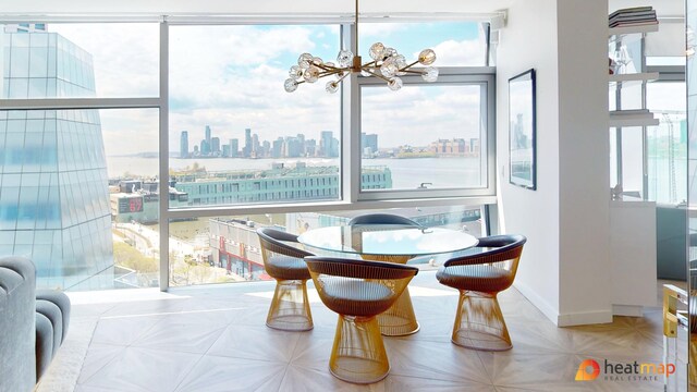 100 11th Ave Unit 12-B, New York City, NY 10011 - dining space with a skyline view, a chandelier, and baseboards