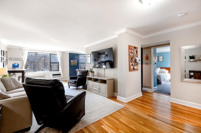 living room featuring light wood-type flooring, ornamental molding, and baseboards