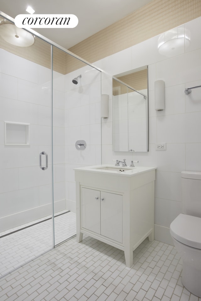 full bath with vanity, tile patterned flooring, toilet, and a shower stall