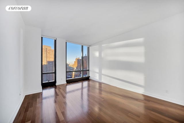101 Warren St Unit 1720, New York City, NY 10007 - empty room with wood finished floors and a city view