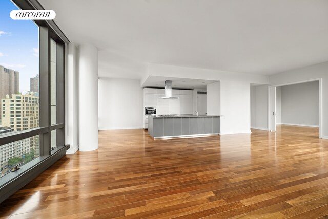 101 Warren St Unit 1720, New York City, NY 10007 - unfurnished living room with light wood-type flooring