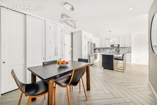 340 E 80th St Unit 1D, New York City, NY 10075 - dining room featuring a chandelier and recessed lighting