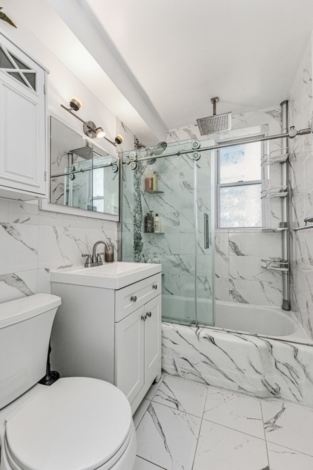 18-70 211th St Unit 5K, New York City, NY 11360 - full bathroom with toilet, plenty of natural light, vanity, marble look tile flooring, and tile walls