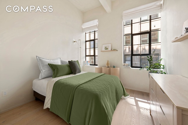 bedroom with wood finished floors and baseboards