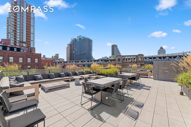 view of patio / terrace featuring outdoor lounge area, a view of city, and outdoor dining space