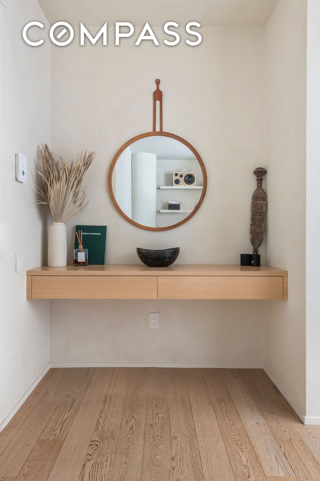 room details with baseboards and wood finished floors