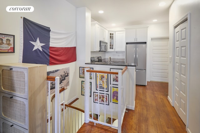 658 Park Pl Unit 1, New York City, NY 11216 - kitchen featuring freestanding refrigerator, stainless steel microwave, glass insert cabinets, dark countertops, and white cabinetry