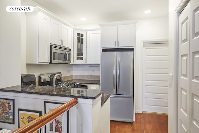 658 Park Pl Unit 1, New York City, NY 11216 - kitchen featuring stainless steel appliances, glass insert cabinets, dark wood-style flooring, a peninsula, and white cabinets