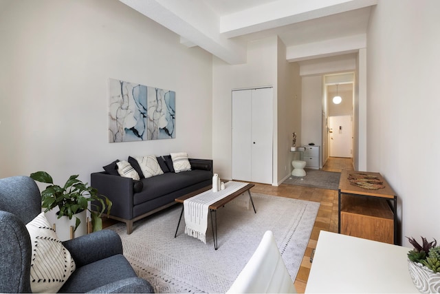 living room featuring light wood-style floors and beamed ceiling