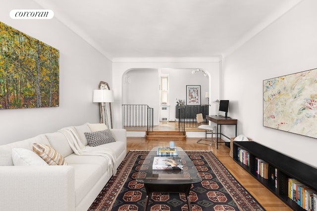 210 W 19th St Unit 2D, New York City, NY 10011 - living room featuring arched walkways, wood finished floors, and visible vents