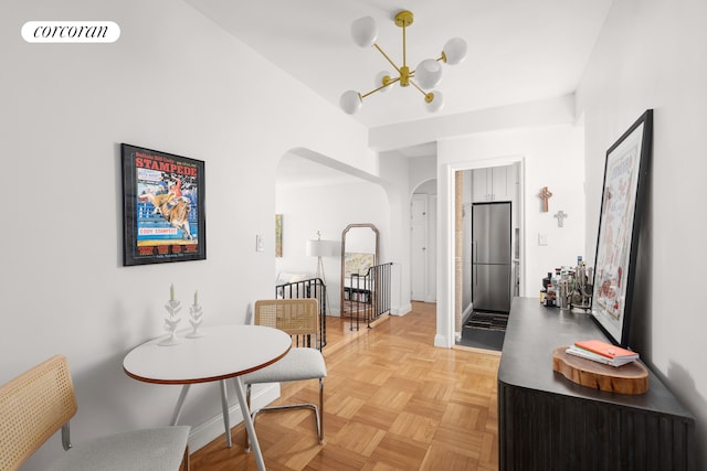 210 W 19th St Unit 2D, New York City, NY 10011 - dining room featuring arched walkways, baseboards, a notable chandelier, and visible vents