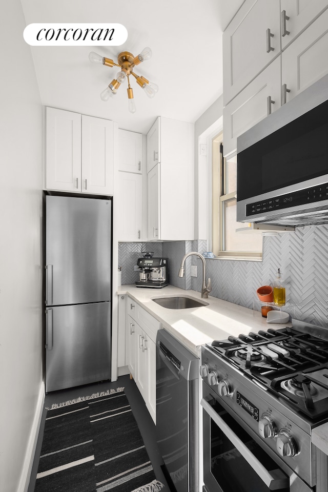 210 W 19th St Unit 2D, New York City, NY 10011 - kitchen with a sink, appliances with stainless steel finishes, tasteful backsplash, and light countertops