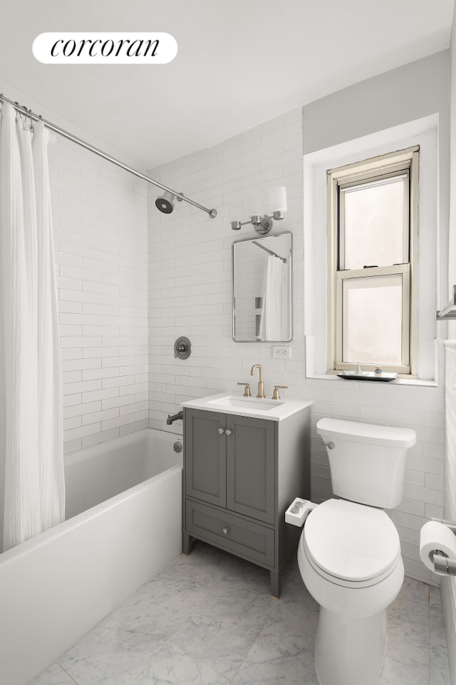 210 W 19th St Unit 2D, New York City, NY 10011 - bathroom with shower / bath combination with curtain, tile walls, vanity, toilet, and marble finish floor
