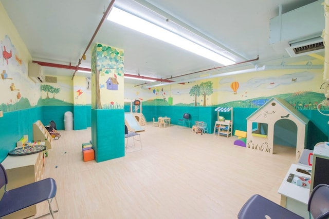playroom featuring a wall mounted air conditioner