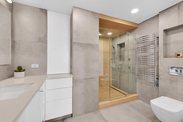 bathroom with vanity, toilet, radiator heating unit, recessed lighting, and a shower stall