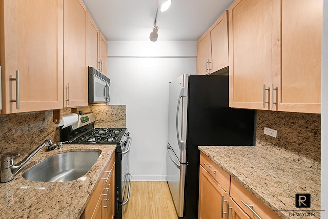 240 E 55th St Unit 5-C, New York City, NY 10022 - kitchen featuring appliances with stainless steel finishes, a sink, light brown cabinets, and decorative backsplash