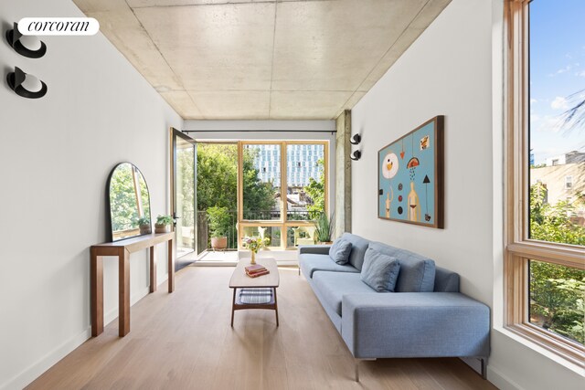 1118 Fulton St Unit 5R, New York City, NY 11238 - living area featuring wood finished floors, healthy amount of natural light, and baseboards