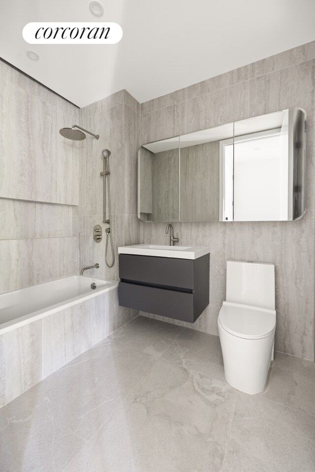 1118 Fulton St Unit 5R, New York City, NY 11238 - full bathroom with tile walls, vanity, tiled shower / bath combo, and toilet