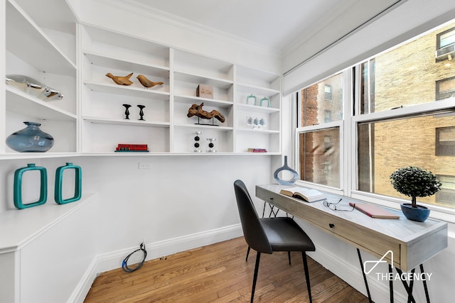 home office featuring wood finished floors, crown molding, and baseboards