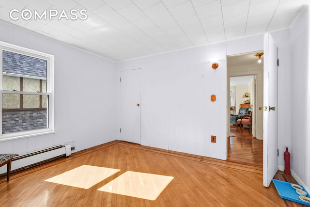 642 E 26th St, New York City, NY 11210 - spare room with a baseboard radiator, wood-type flooring, and ornamental molding