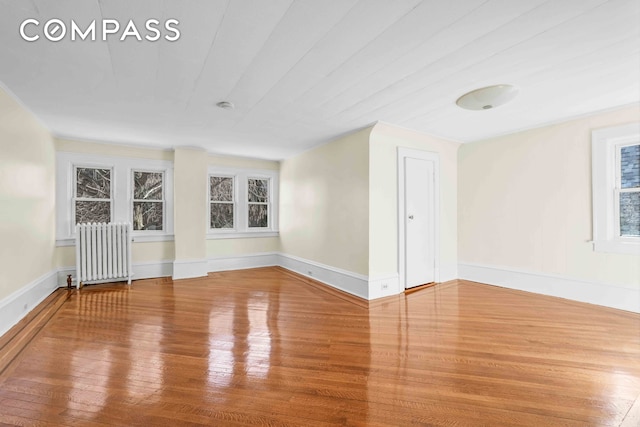 642 E 26th St, New York City, NY 11210 - unfurnished room featuring radiator, wood finished floors, and baseboards