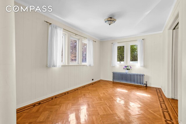 empty room with radiator and baseboards