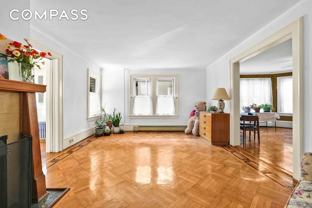 living area featuring baseboard heating and baseboards