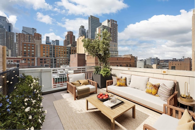 view of patio / terrace with outdoor lounge area, a view of city, and a balcony