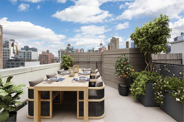 view of patio with fence and a city view