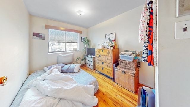bedroom with light wood finished floors