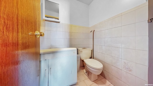 bathroom with tile walls, tile patterned flooring, and toilet