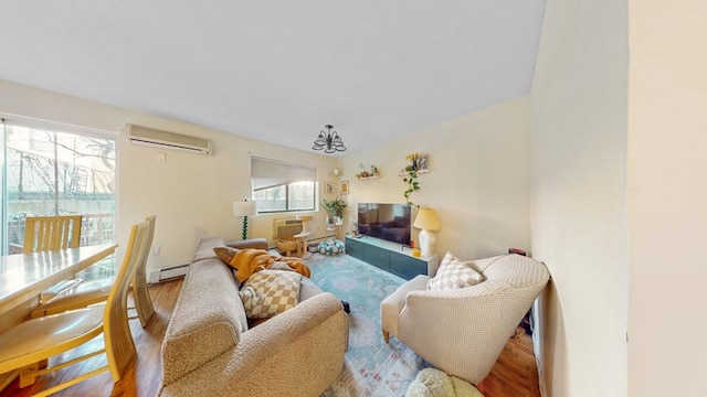 living area with an AC wall unit and wood finished floors