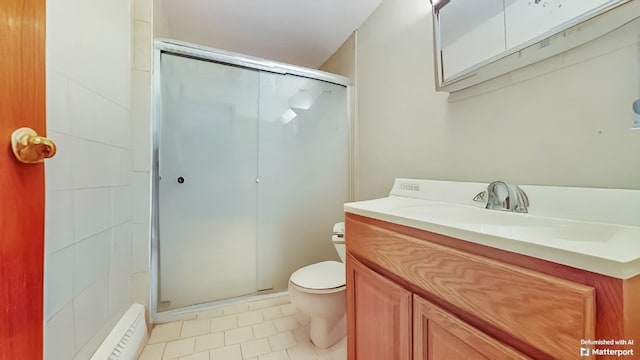 bathroom featuring vanity, tile patterned floors, a stall shower, and toilet