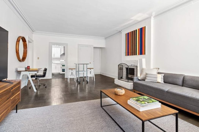 living room with crown molding, wood finished floors, and a fireplace