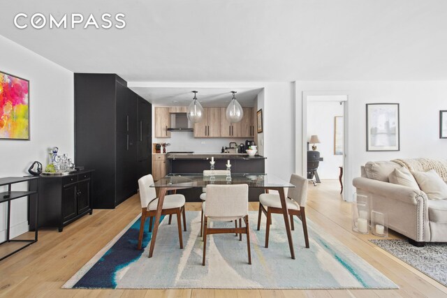 225 E 57th St Unit 14E, New York City, NY 10022 - dining space featuring light wood-style floors