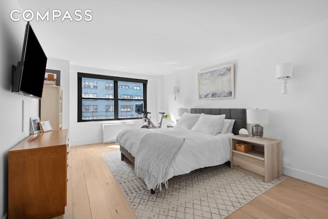 bedroom with baseboards and light wood-style flooring