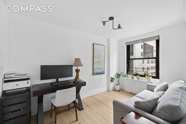office space with baseboards and wood finished floors
