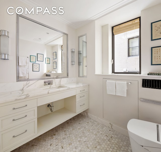 bathroom with vanity, crown molding, toilet, and tile patterned floors