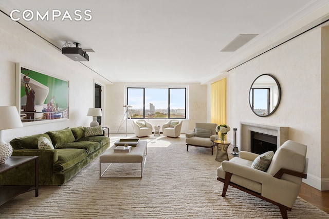living area with a high end fireplace and baseboards