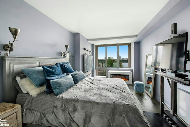 120 Riverside Blvd Unit 3N, New York City, NY 10069 - bedroom with wood finished floors, a glass covered fireplace, and floor to ceiling windows