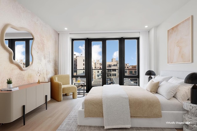 bedroom featuring recessed lighting, wood finished floors, and access to outside