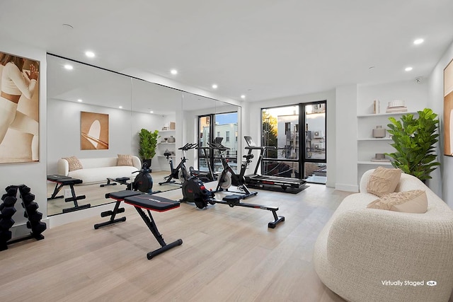 workout room featuring recessed lighting and wood finished floors