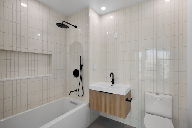 bathroom with shower / bath combination, tile walls, vanity, and toilet