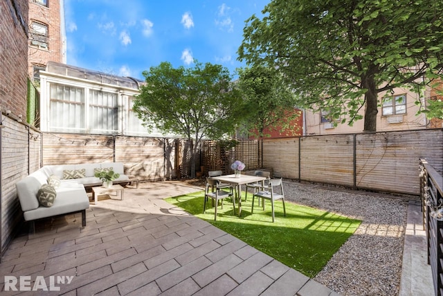 143 Meserole St Unit 1A, New York City, NY 11206 - fenced backyard with a patio area and an outdoor hangout area