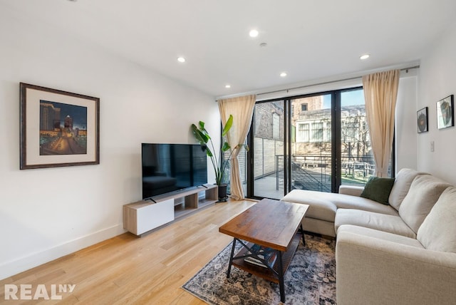 143 Meserole St Unit 1A, New York City, NY 11206 - living area with light wood-style flooring, baseboards, and recessed lighting