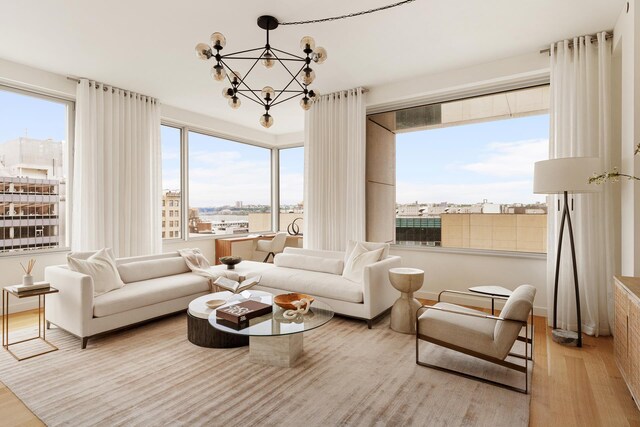 611 W 56th St Unit 12, New York City, NY 10019 - living area featuring a chandelier, wood finished floors, and a view of city