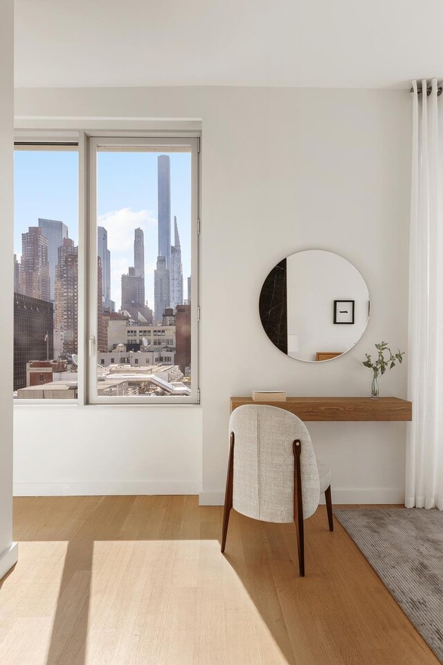 611 W 56th St Unit 12, New York City, NY 10019 - living area with wood finished floors and a skyline view