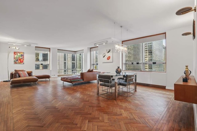 dining space with a notable chandelier and baseboards