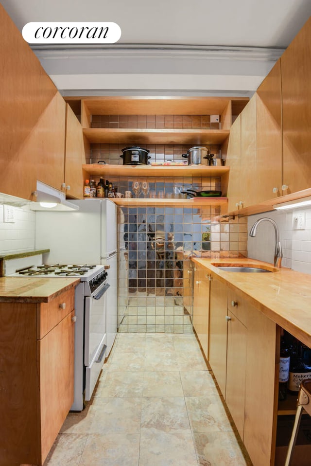 157 E 72nd St Unit 9J, New York City, NY 10021 - kitchen featuring white gas stove, wooden counters, and decorative backsplash